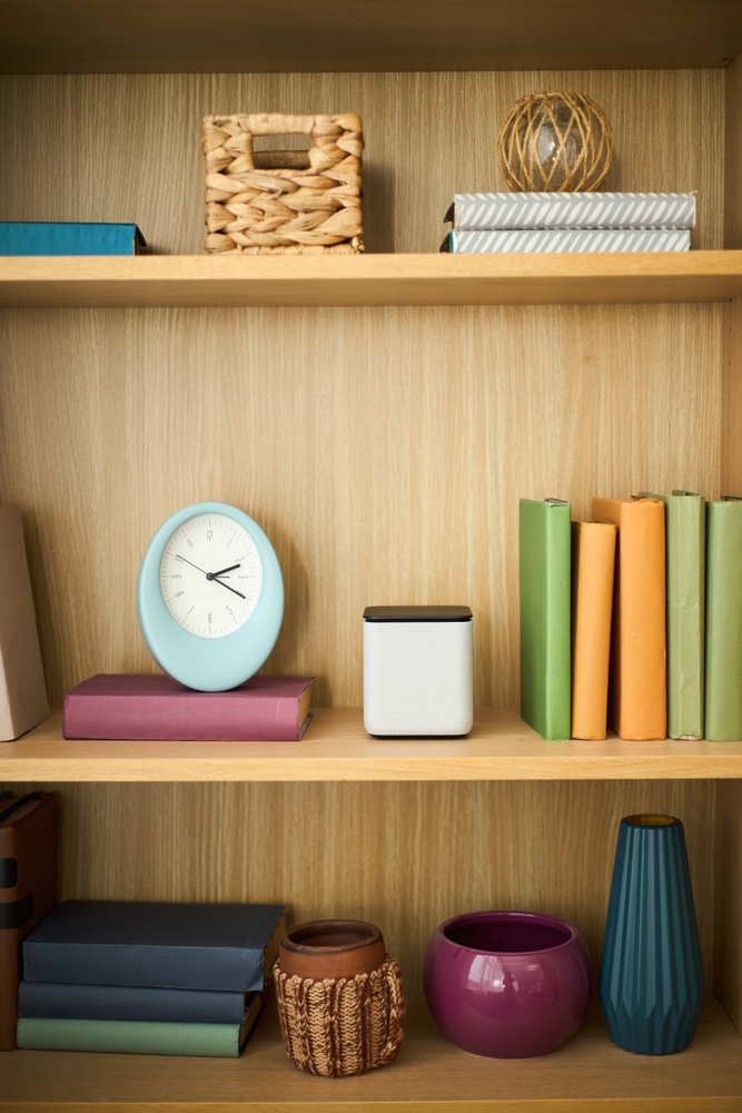 Wooden,Bookshelf,Holding,Smart,Speaker,And,Assorted,Colorful,Books,,Decorative