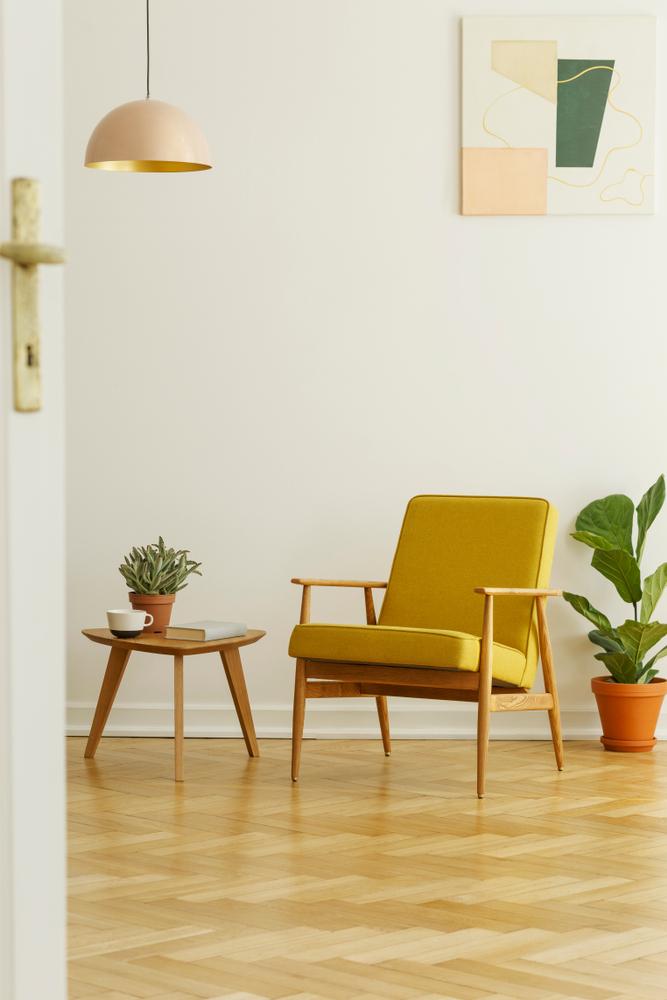 Yellow,Armchair,And,Coffee,Table,With,A,Cup,And,Plant