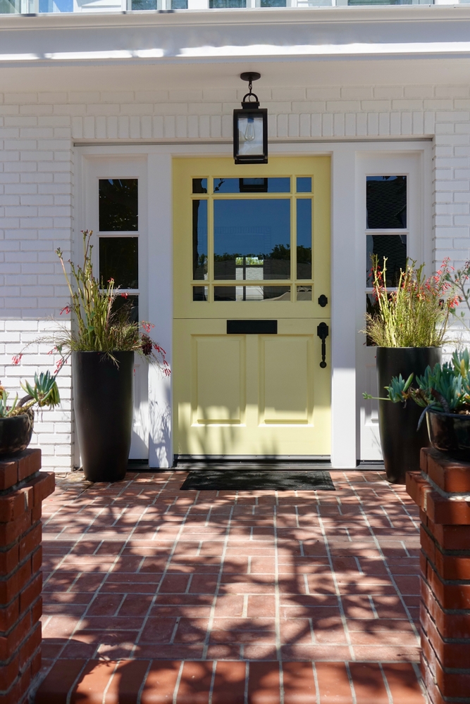 Inviting,Front,Entry,With,Brick,Patio,And,Yellow,Dutch,Door
