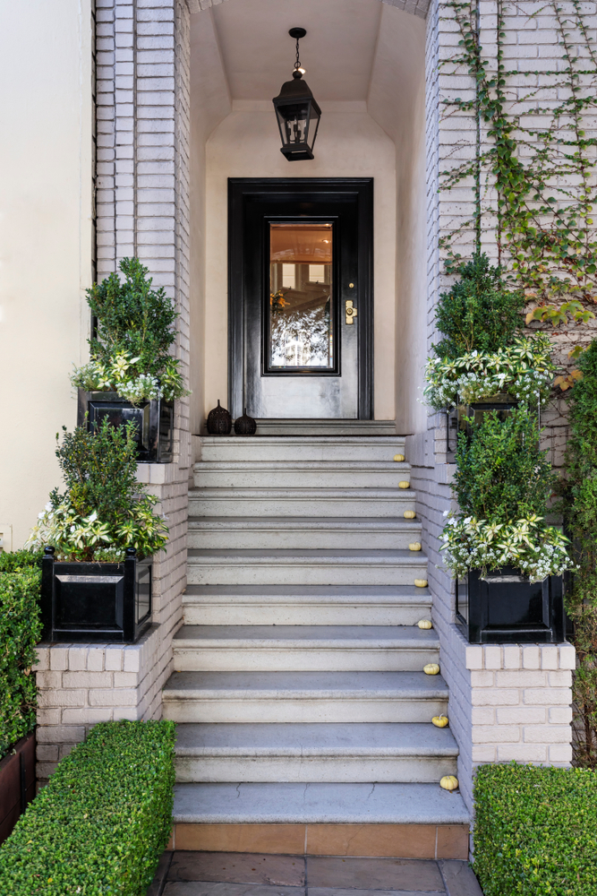 Stairs,Leading,Up,To,A,Secured,Front,Black,Door,Flanked