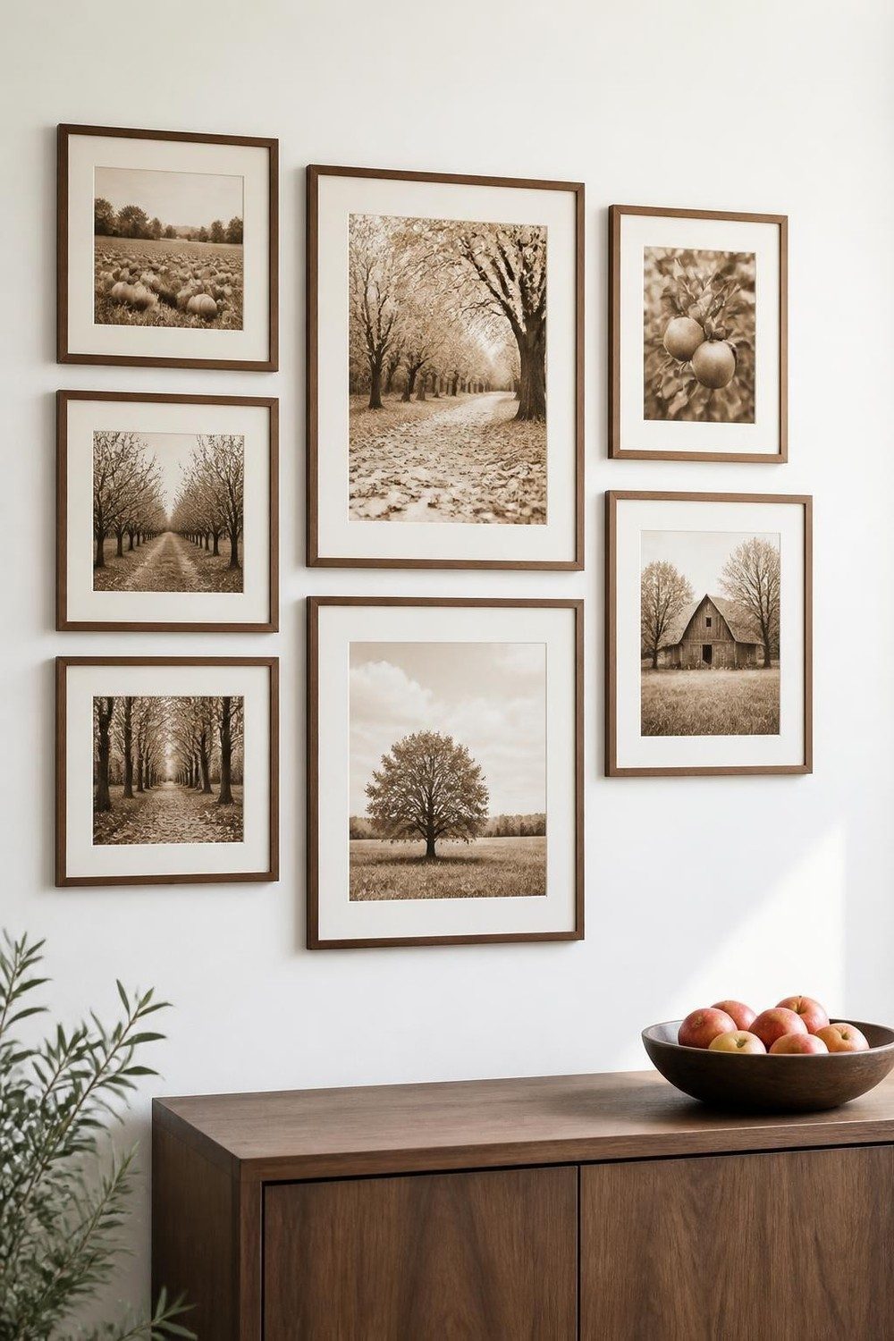 Walnut frame gallery wall of sepia autumn scenery photos on an ivory wall